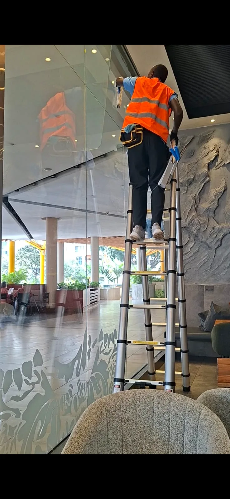 NUVORA technician cleaning commercial interior glass